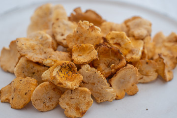 Raw wild mushrooms chanterelles in bowl on old wooden backgroundRaw wild mushrooms chanterelles in bowl on old wooden background