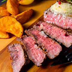 rustic medium butter beef steak with herbs and potato wedges