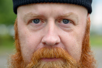 Close up cropped portrait of a redheaded man