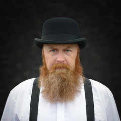 Stern bearded man staring intently at the camera