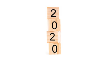 Happy new year 2020 text on wooden cubes on white background. Banner with copy space for text.