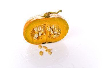 Pumpkin on a white background is cut in half. Pumpkin seeds.
