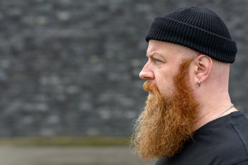 Profile view of a bearded redhead man