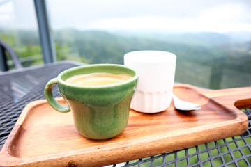 Cup of coffee and tea in the beautiful sky of mountains,traveling on holiday concept .