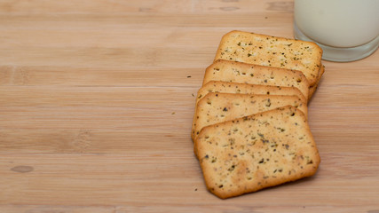 biscuits and a glass of milk on wooden board