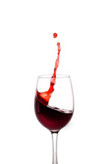 splash of red wine in glass isolated on white background.