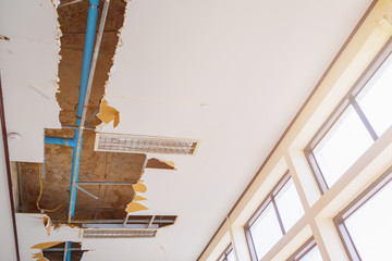 repair leak water pipe on gypsum ceiling interior office building