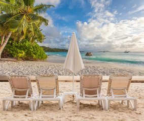 chairs and umbrella on the beach, anse Lazio, Seychelles 