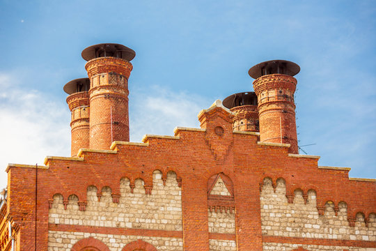 Russia, Samara, June 2019: the roof of the red brick of the Samara Zhigulevsky brewery against the background of the Volga River on a summer sunny day.