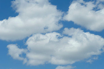 Blue sky texture background with white fluffy clouds. Abstract, cropped shot, horizontal. Nature's concept