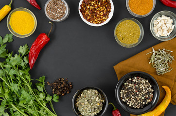 Group of bowls full of spices on black background