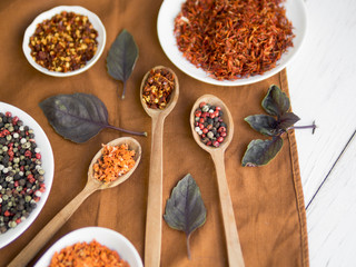 Spoons full spices with dry leaves