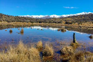Fototapeta na wymiar Mountain reflections in a small mountainous tarn