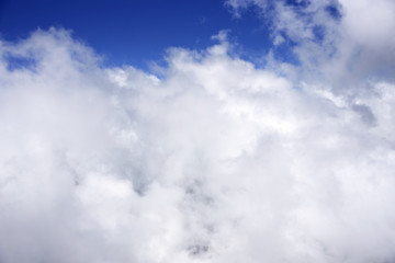A view of the blue sky and clouds seen from the mountain as if flying in the sky