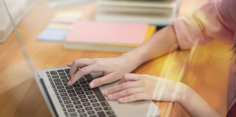 Fototapeta na wymiar Young female student typing on laptop keyboard