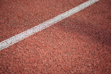 Sport. A red treadmill or athletics track at the stadium. Copy space