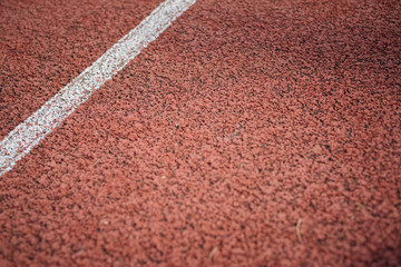 Sport. A red treadmill or athletics track at the stadium. Copy space