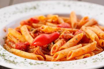 Plate of pasta with tomato , Italian healthy food , wood background.