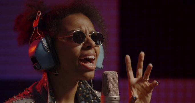 Woman singing in recording booth