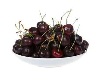 Close up on porcelain bowl full of fresh organic dark red Bing cherries. Bing cherries are dark red and very round, not to mention very sweet