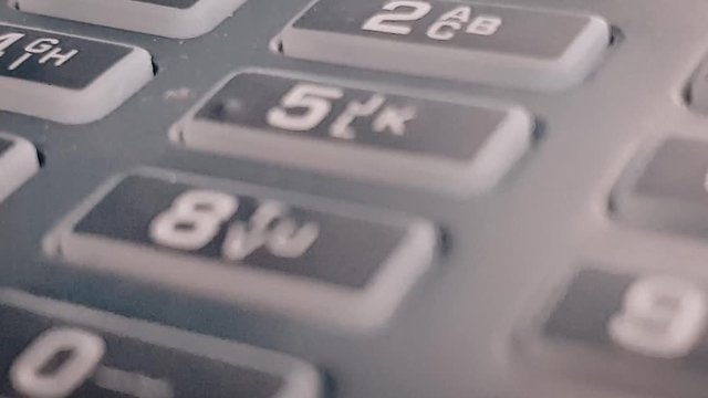 Macro closeup review of the pos terminal and pin pad numbers. Leading to submit ok button. Keyboard on black POS terminal.
