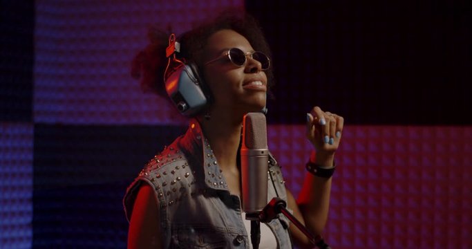 Woman singing in recording booth