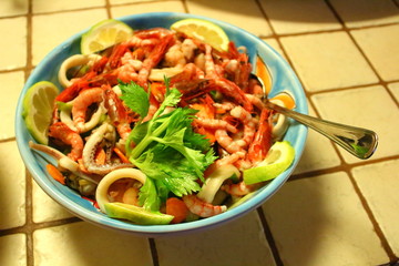 evocative image of fish salad with parsley and lemon