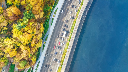 Aerial top view of road automobile traffic jam of many cars from above, Dnipro river and Kyiv autumn cityscape, city transportation concept
