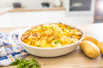 Roasted potatoes with spices and herbs on kitchen table