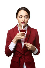 Portrait of elegant female sommelier on white background