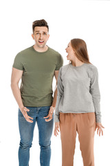 Fototapeta premium Young quarrelling couple on white background