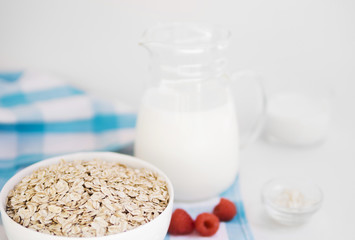 Oatmeal bowl with raspberry and milk
