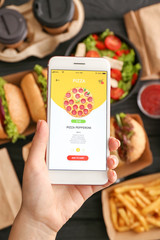 Woman with mobile phone ordering food online