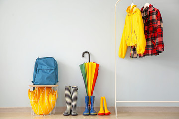 Stylish umbrella with gumboots in hall