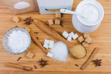 White and brown sugar in different forms and some spices