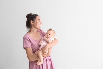 Happy mother with cute little on white background