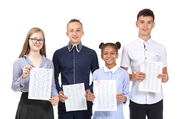 Happy classmates with results of school test on white background