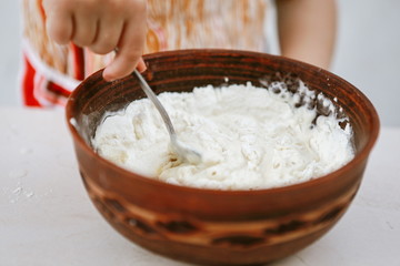 baby hands knead the dough in a pizza plate