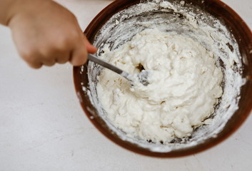 baby hands knead the dough in a pizza plate