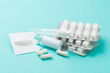 Set of vial bottles and pills on blue background. Medicine, health care and pharmaceutical drugs concept.- Image