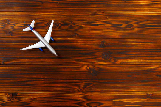 top view photo of toy airplane over wooden background .