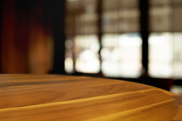 empty wood table with blur montage coffee shop or restaurant background.