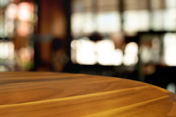 empty wood table with blur montage coffee shop or restaurant background.