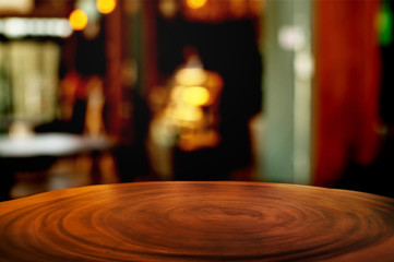 empty wood table with blur montage coffee shop or restaurant background.