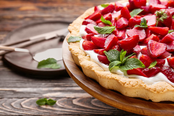 Tasty strawberry cake on wooden table, closeup