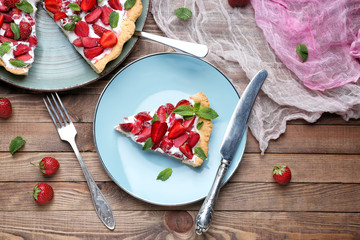 Tasty strawberry cake on wooden table