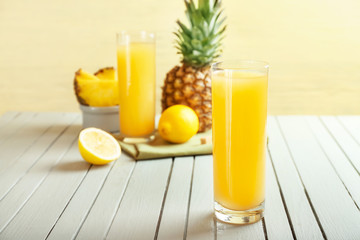 Glass of fresh pineapple juice on wooden table