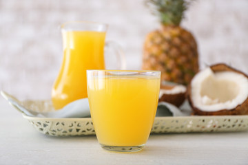 Glass of fresh pineapple juice on table