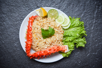 Fried Rice crab seafood - Healthy food fried rice with crab legs with egg lemon and cucumber on white plate