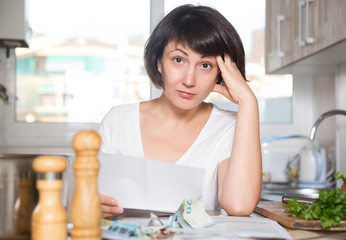 Woman counting money for paying bills